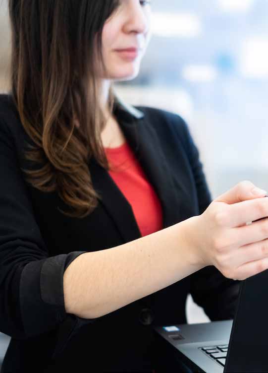 a woman holding a laptop