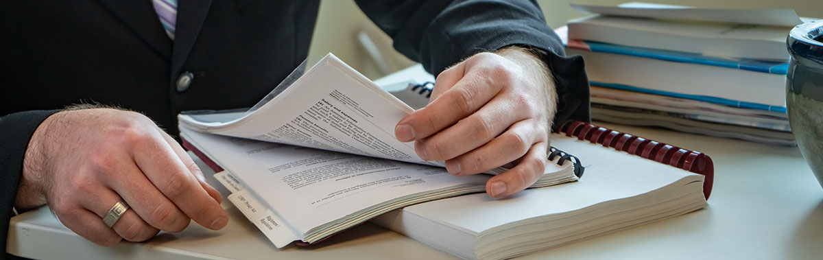 Hands of a person who is consulting a book